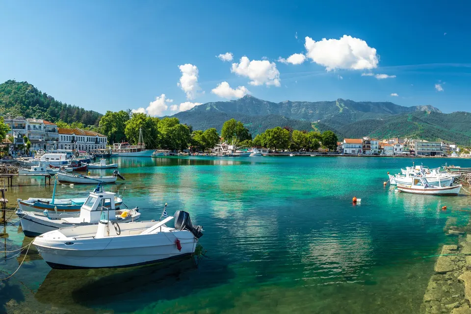 Den gamle havn i Limenas på Thassos med turkis vand, små både og bjerge